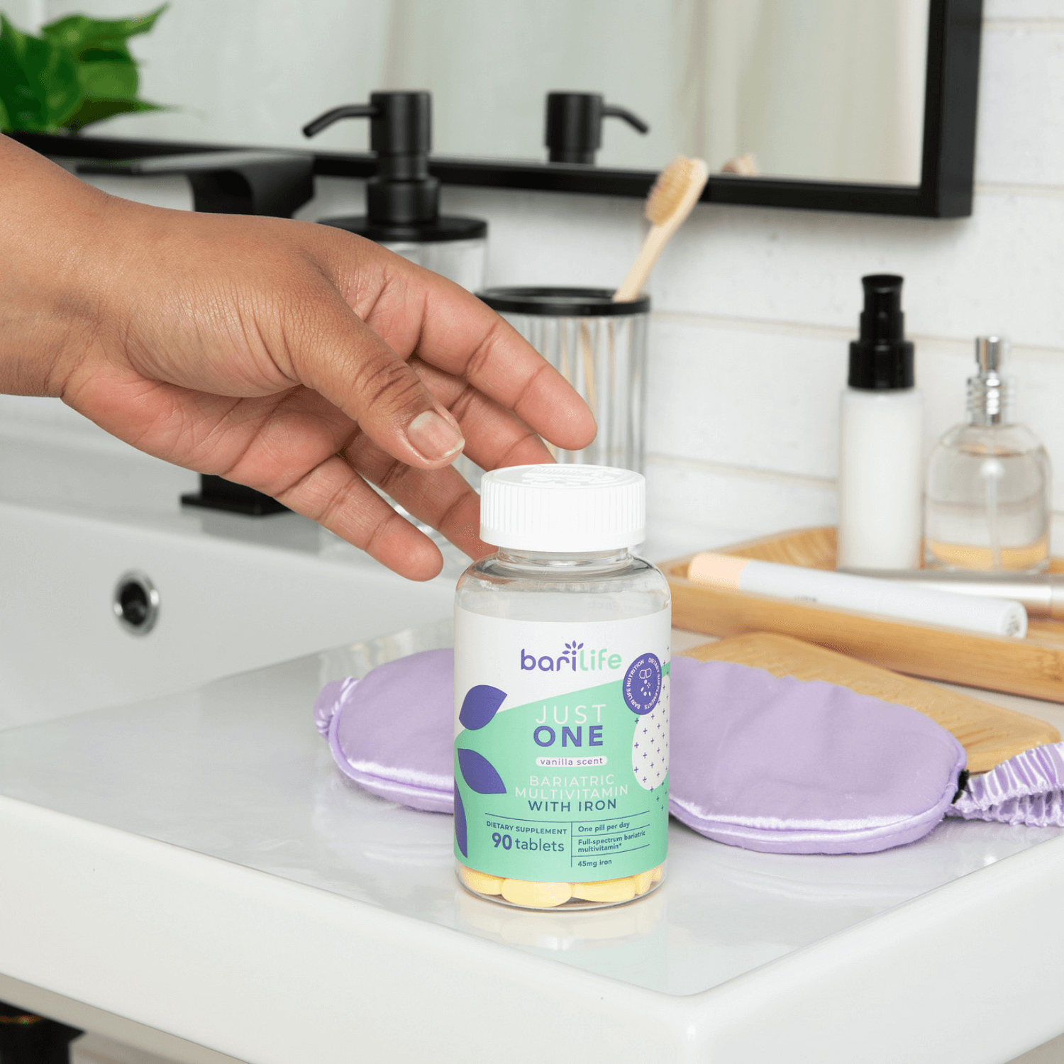 Bariatric multivitamin with iron (45mg) in a bottle on a bathroom counter, featuring 90 tablets for daily health.